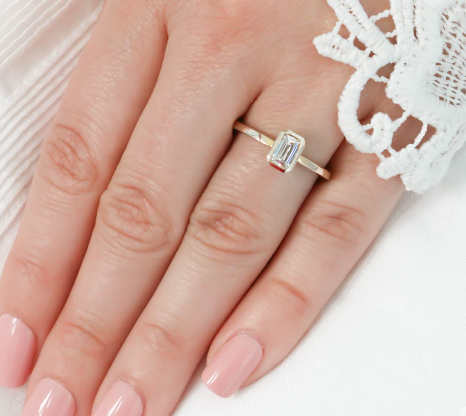 emerald cut engagement rings on finger